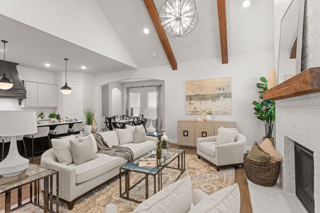 Unified LVP flooring, contrasting island paint, tall ceilings and arched doorways | Image 11