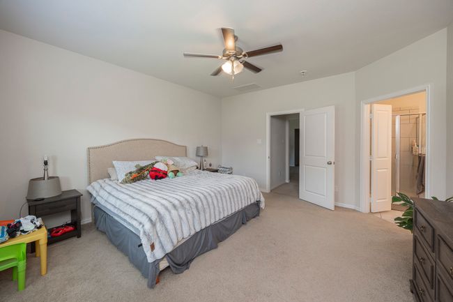Bedroom featuring light carpet and a ceiling fan | Image 31