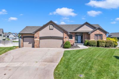 View of front facade featuring a front yard and a garage | Image 1