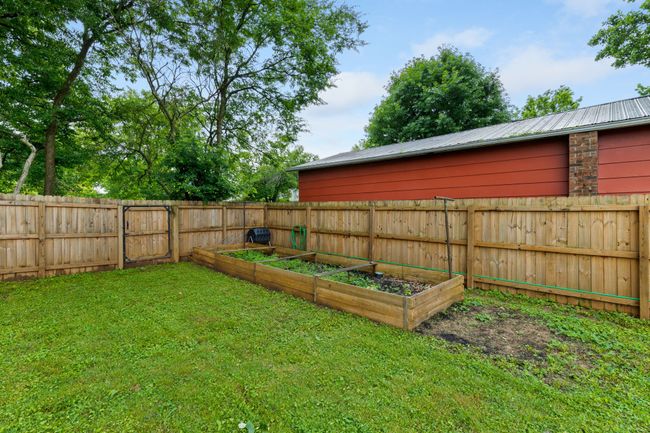 Raised garden beds in the corner of the back yard. | Image 10