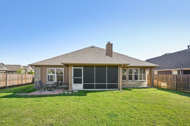 Back of house with a patio area, roof with shingles, a fenced backyard, and a lawn | Image 34