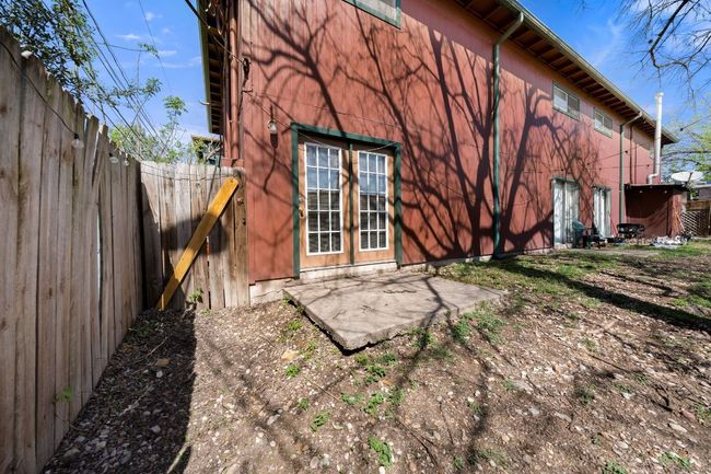 Rear view of house featuring a fenced backyard and a patio area | Image 14