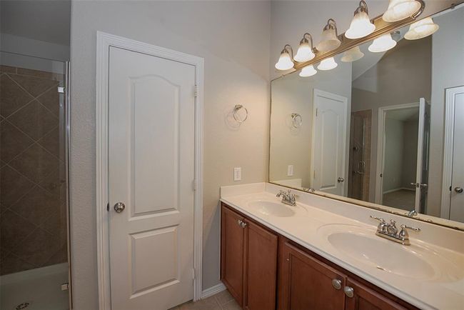 En suite bathroom has double vanity and great storage. | Image 19