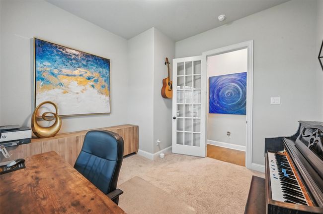 Carpeted home office with baseboards and french doors | Image 7