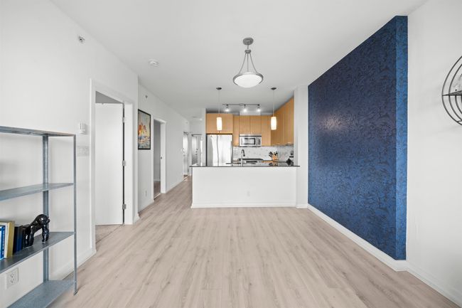 Unfurnished living room with light wood-type flooring, rail lighting, and baseboards | Image 11