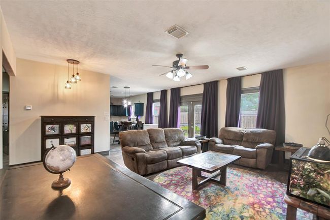 Standing in the family room with a view towards the kitchen and back yard | Image 14