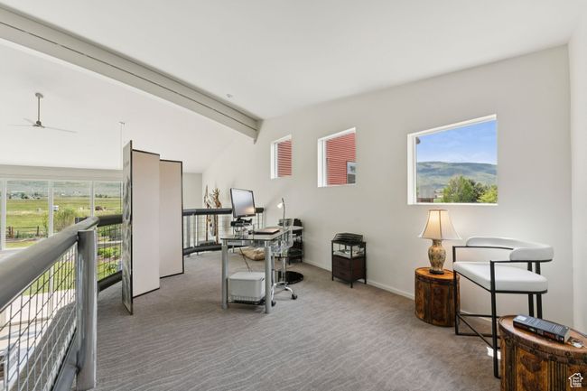 Home office featuring carpet flooring, a ceiling fan, and baseboards | Image 29