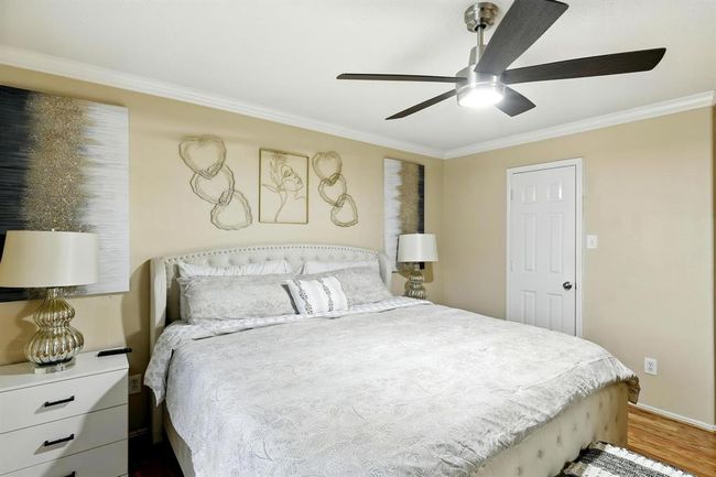 Spacious and inviting, the primary bedroom features neutral tones, with ample space for oversized furniture. | Image 15