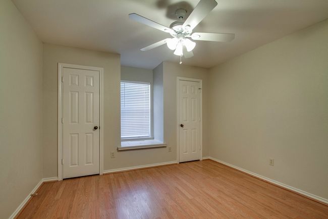Unfurnished bedroom featuring light wood-type flooring and a ceiling fan | Image 16