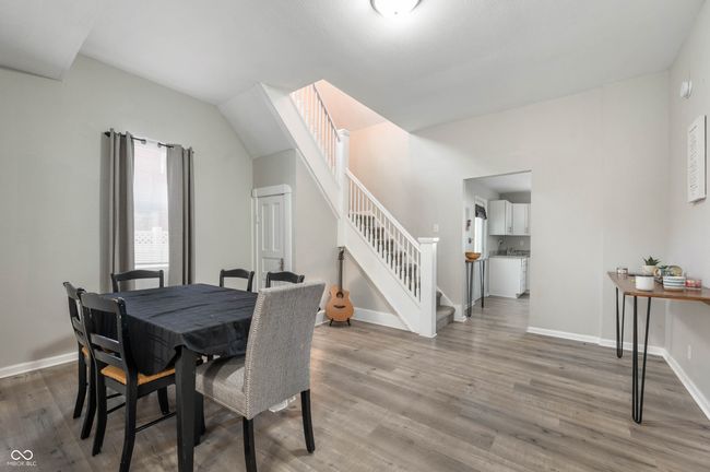 dining area featuring stairs, light wood-type flooring, and baseboards | Image 8