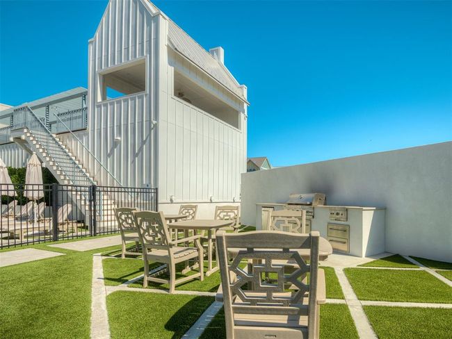 View of yard featuring an outdoor kitchen, stairway, and outdoor dining space | Image 40