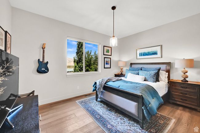 Bedroom with wood finished floors and baseboards | Image 51