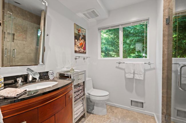 Bathroom with vanity, a shower stall, and tile patterned floors | Image 14