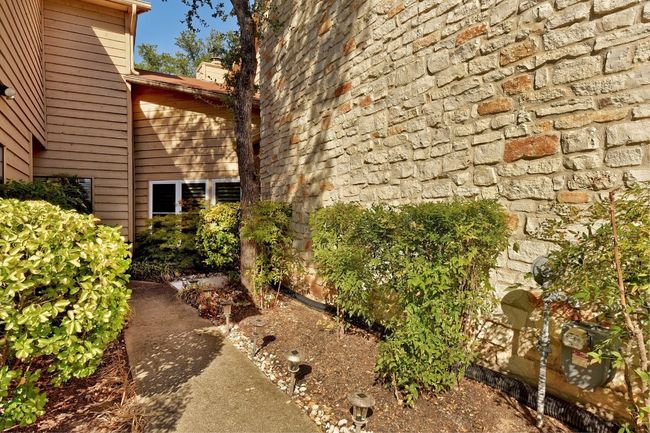 Charming landscaping leads you to the front door. | Image 4
