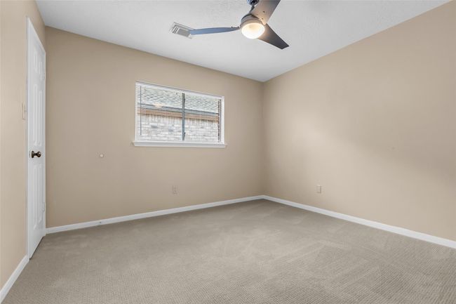 Secondary bedroom #2 with new carpet, ceiling fan and walk-in closet. | Image 22