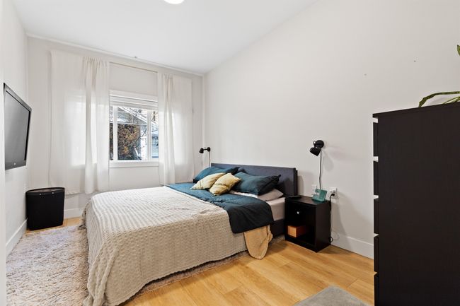 Bedroom featuring lofted ceiling, baseboards, and wood finished floors | Image 13