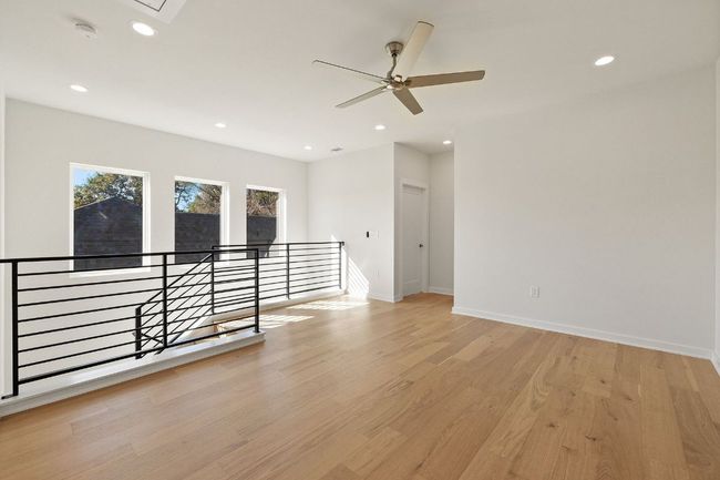 Second floor living with recessed lighting, attic access, ceiling fan, light wood flooring, and baseboards | Image 20