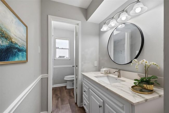 The secondary bathroom offers both style and functionality, featuring a spacious layout. Thoughtfully designed, it provides convenience for multiple users while maintaining a sleek and modern feel. | Image 28