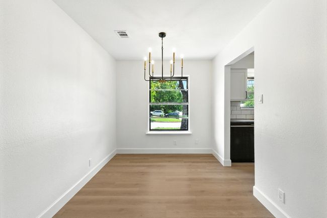 Unfurnished dining area with a chandelier and light wood-type flooring | Image 9