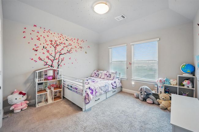 Bedroom featuring carpet and lofted ceiling | Image 35