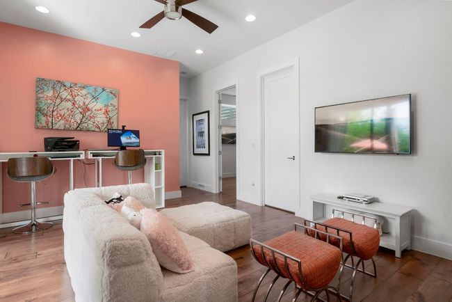 This second living space is on the bottom floor surrounded by guest bedrooms. | Image 33