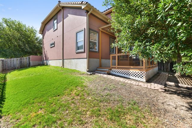 Rear view of house with a deck and stucco siding | Image 36