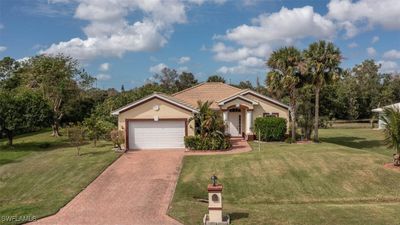 View of front of property with a front lawn and a garage | Image 1