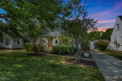 View of property hidden behind natural elements featuring a lawn and a storage unit | Image 2