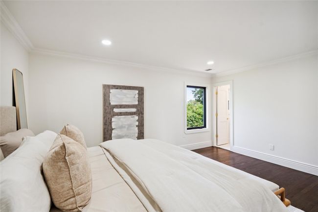 Bedroom featuring dark wood finished floors, crown molding, and recessed lighting | Image 20