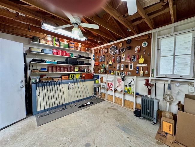 Misc room featuring a workshop area, ceiling fan, and unfinished concrete flooring | Image 36