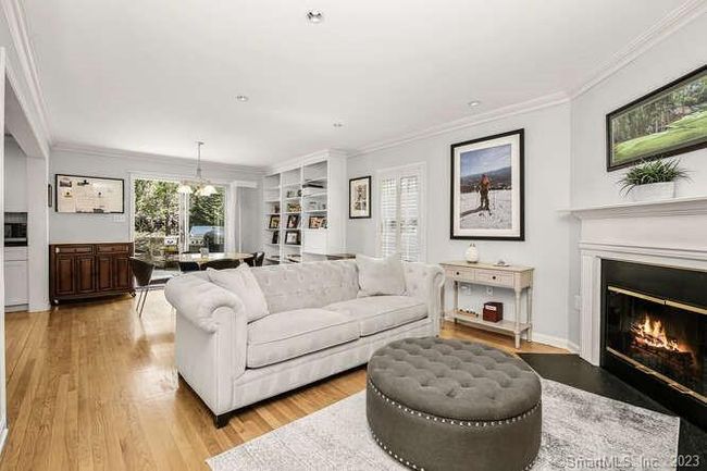 A family room with a fireplace | Image 9