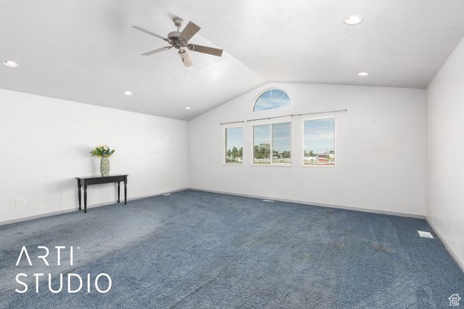 Empty room with ceiling fan, carpet, vaulted ceiling, recessed lighting, and baseboards | Image 27