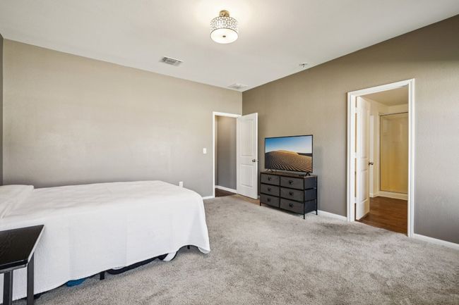 Carpeted bedroom with baseboards | Image 18
