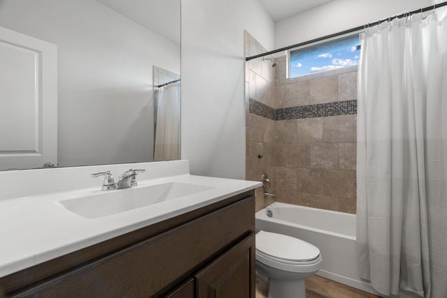 Full bath featuring shower / tub combo, wood finished floors, toilet, and vanity | Image 20
