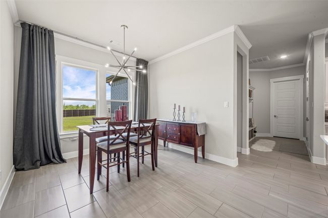 Dining area featuring ornamental molding and chandelier! | Image 8