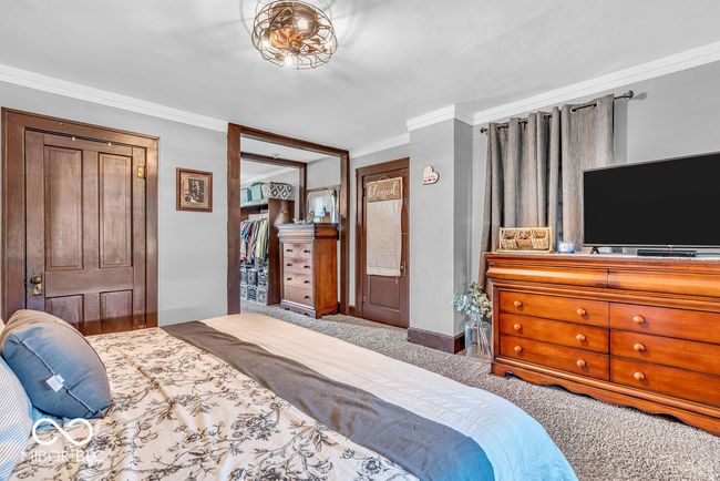 carpeted bedroom with ornamental molding | Image 32