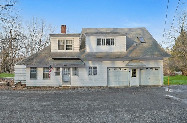 Front of Two Family property with attached garage, and a chimney | Image 40