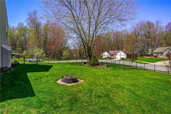 View of yard with an outdoor fire pit and fence | Image 42