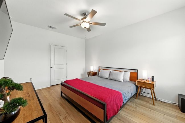 Bedroom with light wood-style floors and a ceiling fan | Image 15
