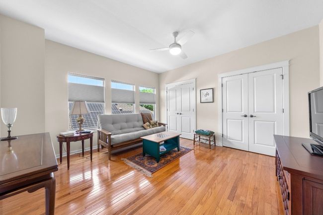 Living room featuring ceiling fan and light wood-style floors | Image 23