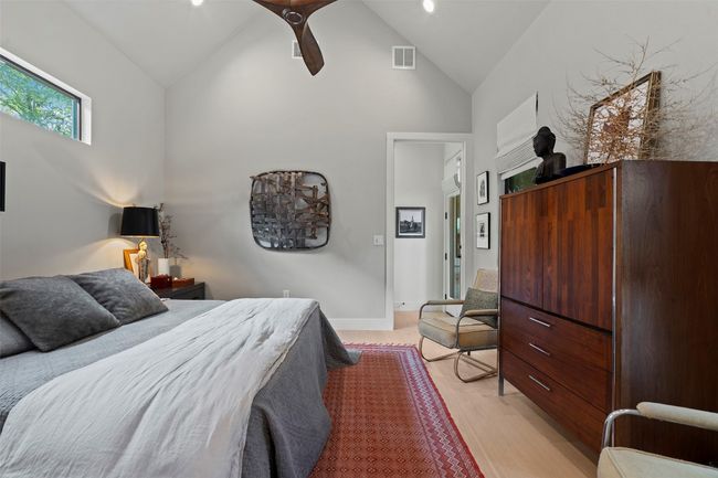 Bedroom featuring high vaulted ceiling, light wood-style flooring, and ceiling fan | Image 24