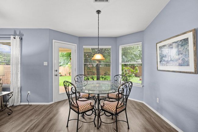 Dining area with LVP floors, and healthy amount of natural light | Image 11