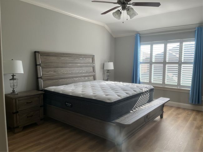 Bedroom with ornamental molding, wood finished floors, and a ceiling fan | Image 10