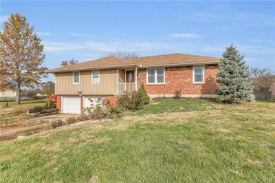 View of front facade with a garage and a front lawn | Image 3