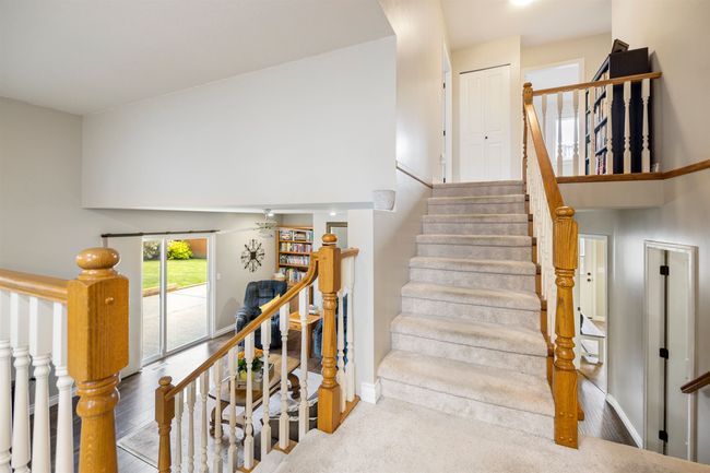 Stairs with a towering ceiling and baseboards | Image 11