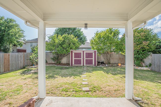View of yard with a fenced backyard, a storage unit, and an outdoor structure | Image 21