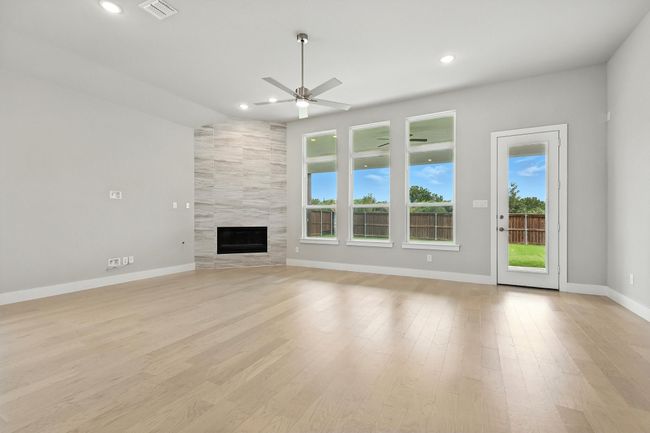 Living room with ceiling fan, plenty of natural light, light wood-type flooring, and recessed lighting | Image 8