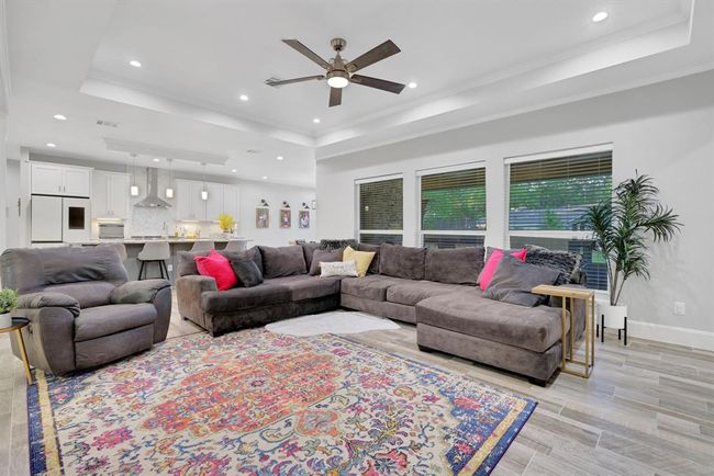 Elegant living area bathed in natural light from stunning, expansive windows. | Image 14