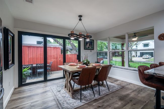 Dining room with wood finished floors and ceiling fan | Image 14