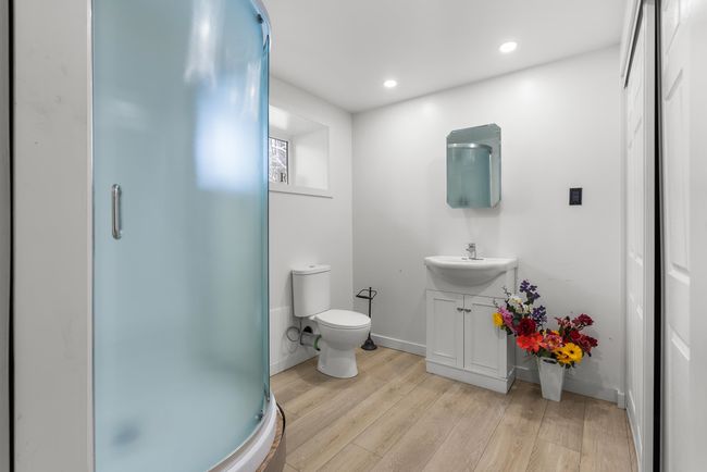 Bathroom featuring a shower stall, toilet, recessed lighting, wood finished floors, and vanity | Image 23